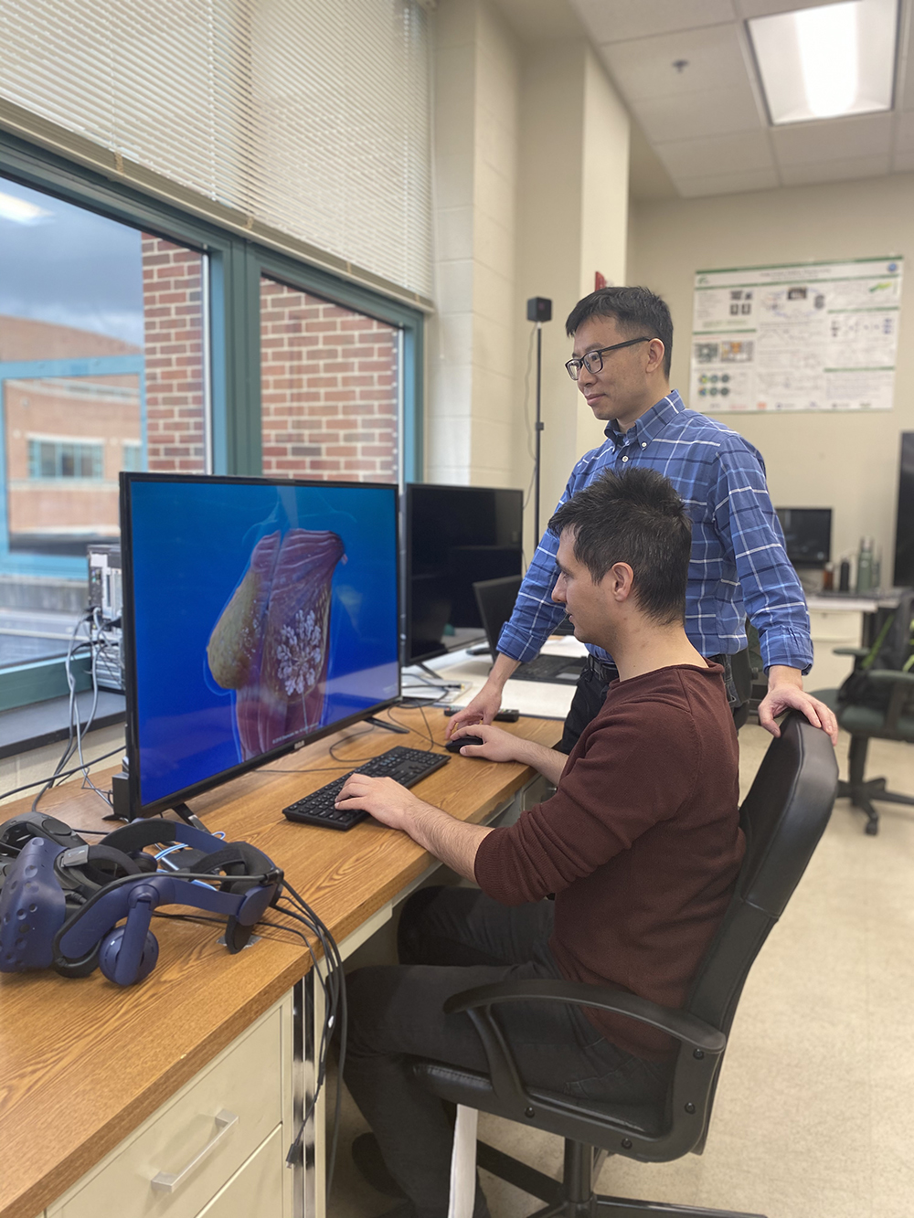 2 men looking at computer